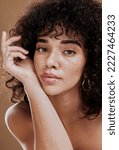Small photo of Skincare, hair care and face of woman with beauty, makeup and cosmetics against a brown studio background. Wellness, luxury and portrait of a girl model at a spa or salon for hair or natural skin