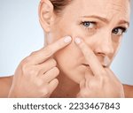 Small photo of Health, skincare and woman squeeze acne in face with studio background. Skin care, morning facial and lady with flaws, blemish and imperfection pop pimple or blackhead with fingers and hands.