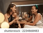 Small photo of Friends, champagne and women in restaurant, party and dinner for bonding. New Years, females and girls enjoy drink, smile and conversation for celebration, bond and happy at social event to relax.