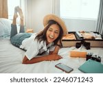 Small photo of Happy, travel packing and woman on a hotel bed with suitcase ready for summer vacation. Luggage, bedroom and smile of a person relax in accommodation with clothes or happiness about traveling journey