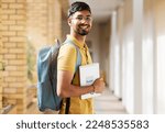 Small photo of College student portrait, happy man and walking at university with a tablet and backpack to study and learn. Gen z male happy about education, learning and future after studying at school building