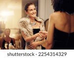Success, handshake or women in a party shaking hands for partnership agreement at social event. Thank you, congratulations or happy people greeting or meeting at luxury dinner gala for winning a deal