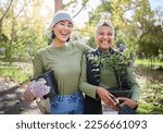 Small photo of Portrait, flowers and women volunteering in park for community, outreach or programme together. Environment, charity and friends volunteer in forest for gardening project, happy and smile in nature