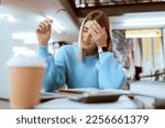 Small photo of Woman student, tired with headache and university burnout, stress about paper deadline or study for exam in library. Campus, college studying fatigue with scholarship problem, pain and mental health