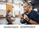 Small photo of Training, senior and man exercise with personal trainer at the gym squat with kettlebell equipment for strength. Elderly, old and fitness people workout in a health club for wellness and motivation