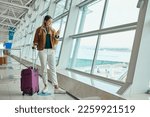 Small photo of Luggage, travel and woman with phone at airport for social media, web scrolling or internet browsing. Suitcase, mobile and happy female on smartphone for networking while waiting for flight departure