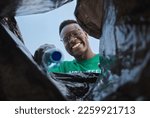 Small photo of Recycle, smile and black man with view in bag, sustainability and cleaning plastic pollution, earth day and help in community. Saving the environment, charity and people putting trash in garbage bin.