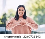 Portrait, heart hands and young woman for self care, cardiology wellness and gen z support for women health. Face of a happy Indian person with love emoji, sign or gesture for like, vote and peace