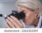 Doctor, microscope and senior woman in laboratory for research, experiment or innovation. Science, biotechnology and elderly female scientist with medical equipment for sample analysis or testing.
