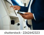 Small photo of Hand, phone and atm with a business black man at the bank to withdraw cash from a convenient machine. Money, finance and smartphone with a male employee making a financial transaction on credit