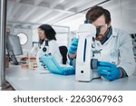 Man, doctor and forensic scientist with microscope for examination, experiment or test at laboratory. Male in science looking at micro organisms for exam, breakthrough or testing to find cure at lab