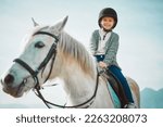 Small photo of Ranch, happy and girl child on a horse to practice riding for a championship, competition or race. Happiness, animal and kid with smile practicing to ride a pony pet on a field or farm in countryside