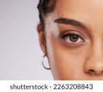 Eye, vision and beauty with contact lens and black woman, care for eyes and cosmetics with closeup on studio background. Microblading, eyebrow and lashes, face and skin in portrait with mockup space