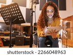 Small photo of Musician, woman or tablet for song writing in recording studio for album, night performance or radio industry. Smile, happy or singer on technology for artist singing lyrics, production or research