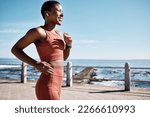 Small photo of Black woman, music earphone or running by beach, ocean or sea in healthcare wellness or cardiovascular strength. Happy smile, sports runner or listening to workout training or marathon exercise radio