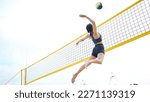 Small photo of Sports, volleyball and woman jump at beach to hit ball in competition, game or match. Training, exercise and female athlete jumping for spike in tournament for workout, fitness and health at seashore