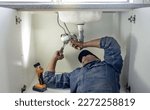 Small photo of Plumber, man and handyman with plumbing, home renovation and manual labour with tools. Construction, DIY skills and professional, fixing pipe in industry and male with trade, repairs and maintenance