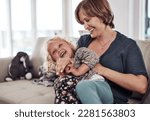 Small photo of Shes always been so ticklish. an attractive young mother sitting and tickling her daughter during a day at home.