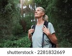 Travel, forest and mature woman on hiking journey, jungle adventure and nature backpack with outdoor explore. Senior camper or hiker person trekking in rainforest or tropical woods for cardio health