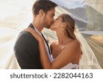Small photo of Couple, wedding and kissing with vail for love, compassion or affection together in nature. Married man kiss woman on lips, hugging in marriage, relationship or loving embrace for commitment outdoors