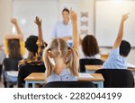 Small photo of Answering, back and children raising hand in class for a question, answer or vote at school. Teaching, academic and a student asking a teacher questions while learning, volunteering or voting