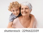 Small photo of Piggyback, portrait and grandmother with child embrace, happy and bonding against a wall background. Love, face and senior woman with grandchild having fun, hug and enjoying the weekend together
