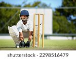 Small photo of Cricket, sports and a man as wicket keeper on a pitch for training, game or competition. Male athlete behind stumps with gear for action, playing professional sport and exercise for fitness or mockup