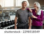 Small photo of Marry someone that makes you laugh and keeps you fit. a senior married couple laughing and taking a break from their workout at the gym.