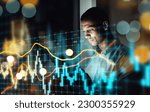 Small photo of Businessman, tablet and dashboard at night of stock market, trading or graph and chart data at office. Man trader or broker working late on technology checking digital trends, analytics or statistics