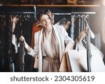 Stylist, rich or happy woman shopping in boutique store looking at clothes or choosing her favorite style. Choice, decision or female designer with trendy apparel picking an outfit or classy fashion