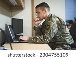 Laptop, thinking and military man with security software, online research and law academy in office. Planning, soldier or young army person on computer, internet search or website information check