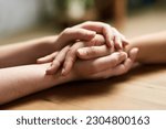 Small photo of Comfort, holding hands and support of friends, care and empathy together on table after cancer. Kindness, love and women hold hand for hope, trust or prayer, solidarity or compassion, help or unity.
