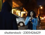 Small photo of Danger, woman fear and criminal in the city at night with thief and anxiety outdoor, Urban, dark and female person feeling scared with stress and terror from stalker, crime and risk of scary violence
