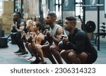 Small photo of Weightlifting, fitness and people with kettle bell in gym for training, exercise and workout class. Teamwork, body builder and men and women squat with weights for challenge, wellness and strength