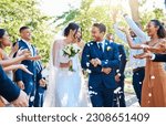 Small photo of Happy, wedding ceremony and couple walking with petals and guests throw in celebration of romance. Romantic, flowers and bride with bouquet and groom with crowd celebrating at outdoor marriage event.