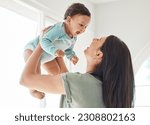 Small photo of Mother holding laughing baby in home for love, care and quality time together to nurture childhood development. Happy mom, carrying and playing with infant girl kid for support, happiness and fun