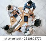 Small photo of Meeting, handshake and overhead with a business team sitting around a table in the office at work. Partnership, thank you and welcome with male colleagues shaking hands in agreement of a b2b deal