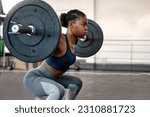 Small photo of Fitness, weightlifting and barbell with black woman in gym for workout, strong and muscle. Health, challenge and exercise with female bodybuilder and weights for focus, performance and commitment