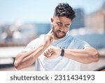 Man, fitness and checking watch for pulse, heart rate or performance after running exercise in city. Fit, active and sporty male person, athlete or runner looking at wristwatch for monitoring in town