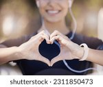 Healthy, heart hands or happy girl runner in park for fitness, exercise or workout for cardiovascular health. Love sign, hand gesture or blurry sports woman in sports training for wellness in nature