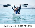 Kayak, sports and team celebrate win on rowing boat on a lake, ocean or river for fitness challenge. Man and woman or winning couple with a paddle for adventure, teamwork exercise or travel on water