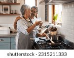 Cheers, wine and old couple at in kitchen cooking food together at stove with smile, love and romance. Toast, drinks and senior woman with man, glass and happiness to make dinner meal in retirement