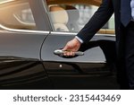 Businessman, hands and chauffeur by car door for travel accommodation, designated driver or commute. Hand of male person on vehicle handle in professional transport service, business class or pick up