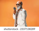 Small photo of Lets jazz things up a little. Studio shot of a senior man wearing vintage clothes while singing into a microphone.
