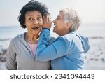 Small photo of Gossip, beach and senior friends with a secret, whisper or talking in ear for a funny joke after outdoor exercise. Laughing, crazy and elderly women listening to conversation or story at the sea