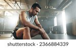 Small photo of Fitness, breathing and sweating with a tired man in the gym, resting after an intense workout. Exercise, health and fatigue with a young athlete in recovery from training for sports or wellness