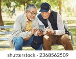 Small photo of Elderly men, friends and phone in park, reading and army memory with thinking, relax and sunshine. Senior military veteran, smartphone social media and talk on bench, nostalgia and remember service