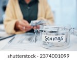 Woman, jar and savings for money, investment or growth in finance, profit or expenses on desk at home. Female person counting cash, bills or paper notes in financial freedom or interest in container