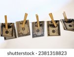 Finance, pegs and money laundering with bank notes on a washing line for white collar crime or fraud. Financial, cash and cleaning with usa dollar currency on a sky background for illegal payment