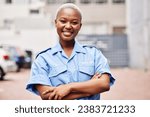 Small photo of Portrait, black woman and security guard smile with arms crossed in surveillance service, safety and city patrol. Law enforcement, proud bodyguard or happy female police officer in blue shirt outdoor